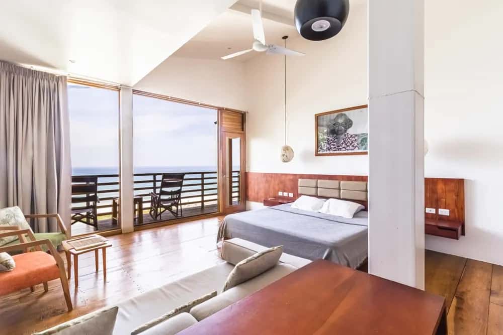 Living area opening onto an ocean-view balcony — Barefoot Chateau 2