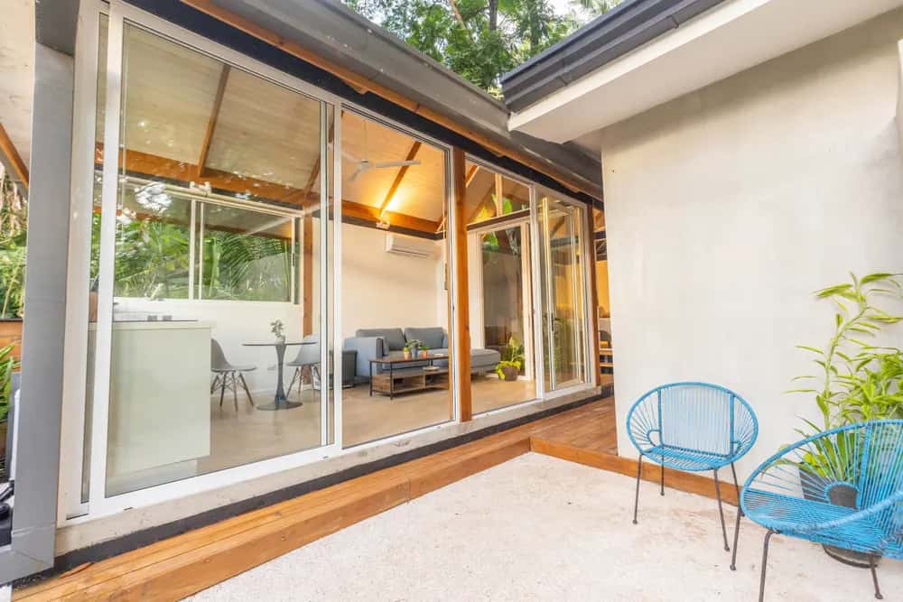 Patio seating beside sliding glass doors — Casa Lumina: Cozy 1BR