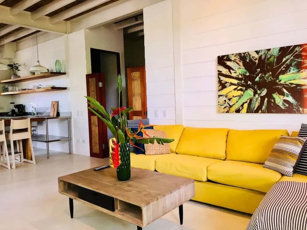 Living room with yellow sofa beside the kitchen — marAmar Luxury Apartment II