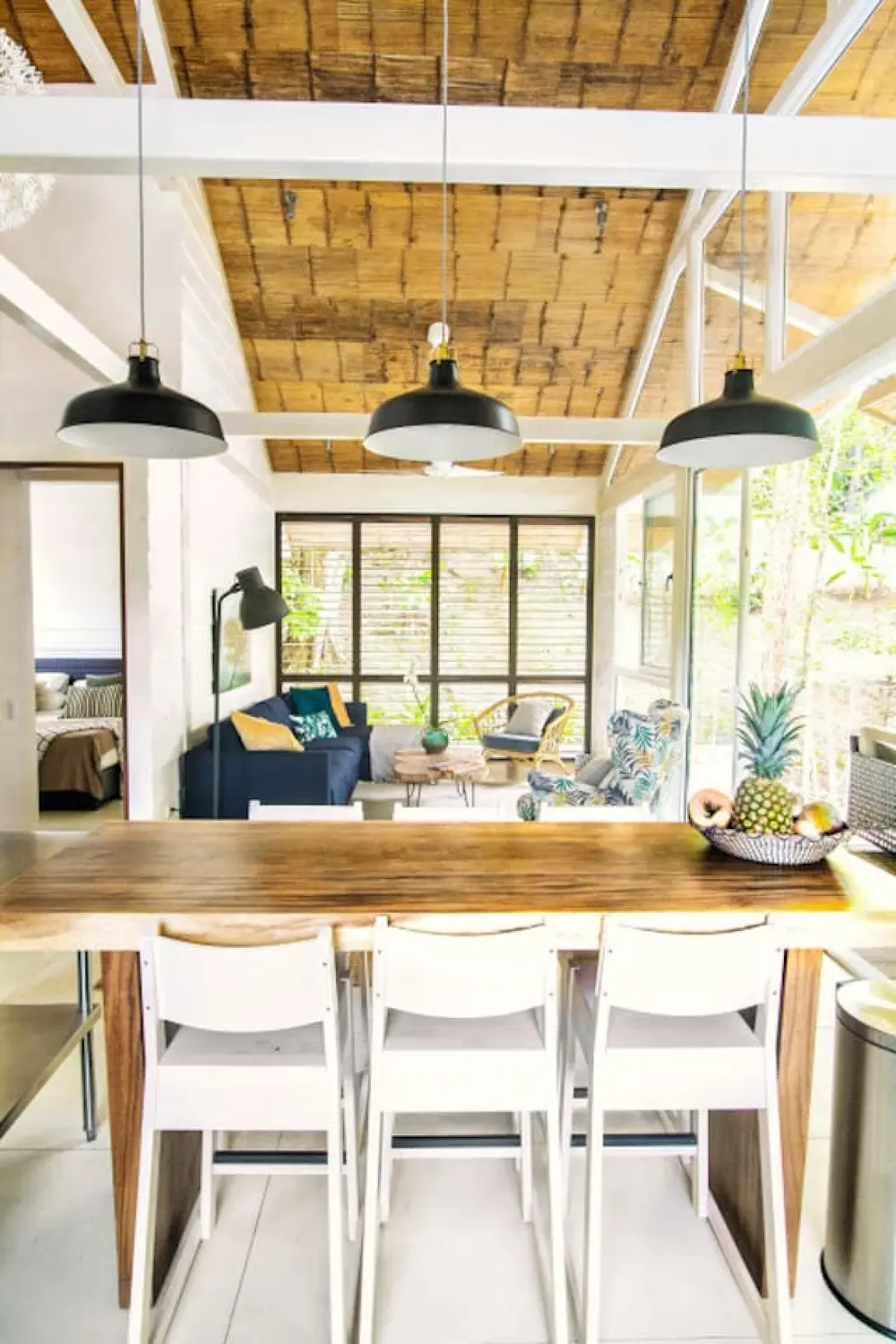 Covered dining area with white chairs and timber ceiling — marAmar Luxury Apartment IV