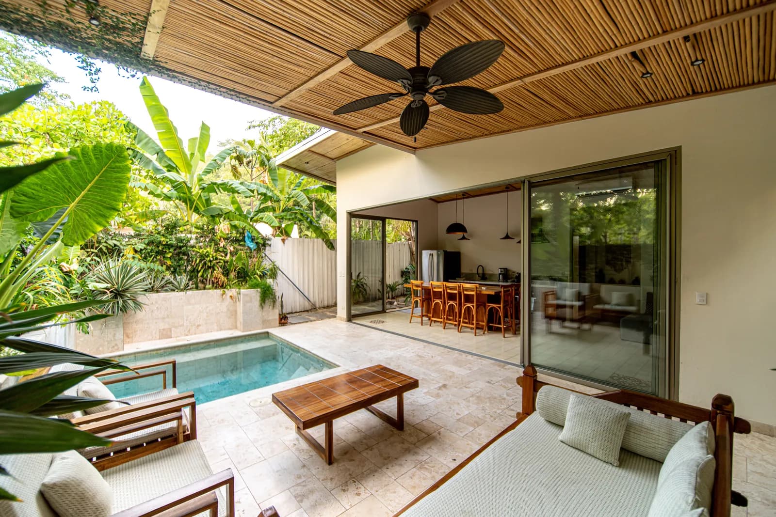 Covered terrace with seating beside the pool — Casa Keshet